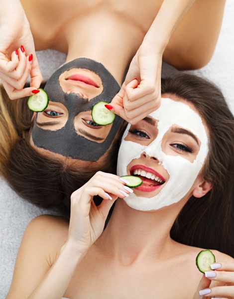 Two clients relaxing with cucumber facial masks at Bella Vous Beauty