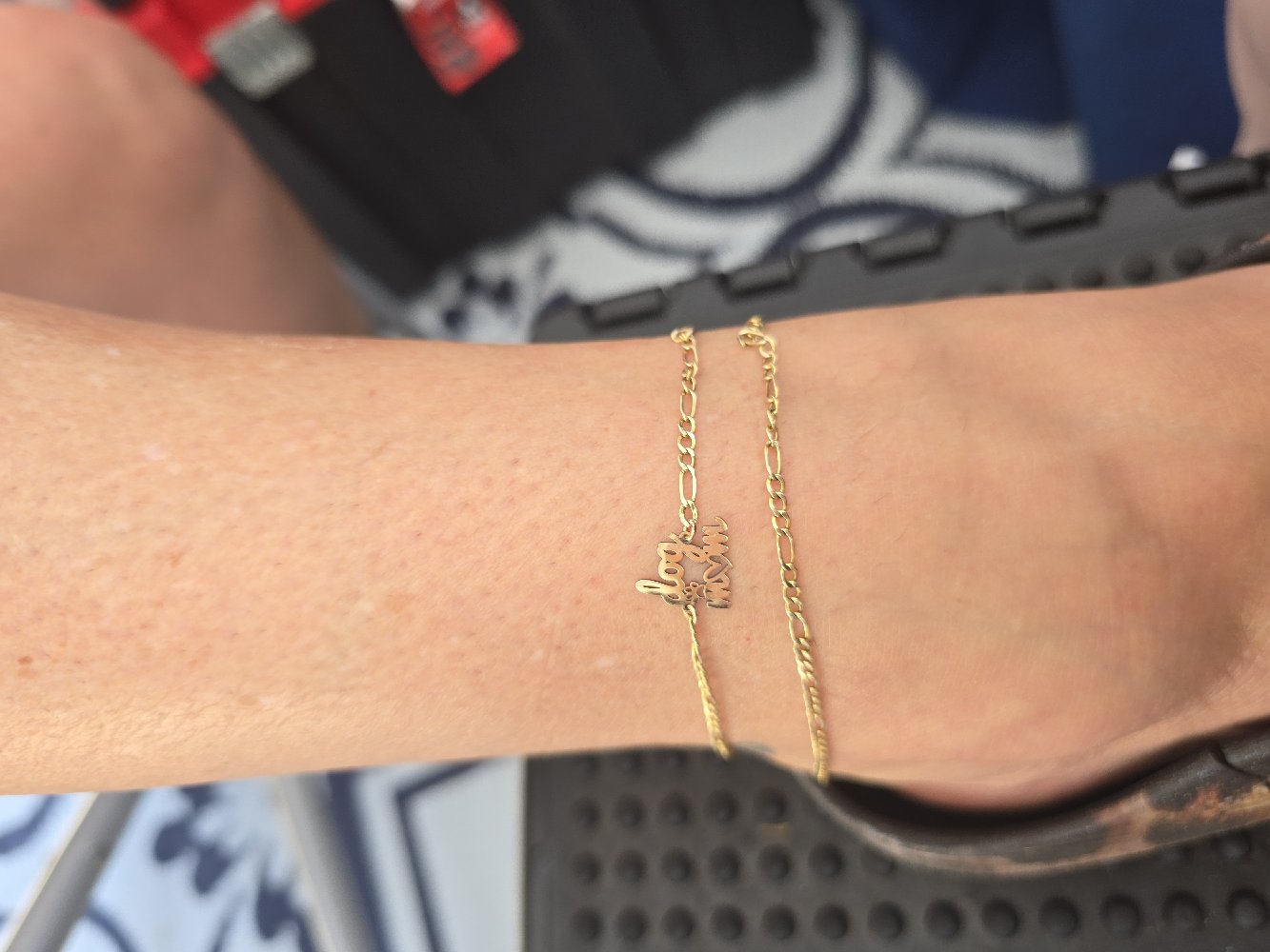 Gold permanent anklet with a dog mom charm welded to the ankle