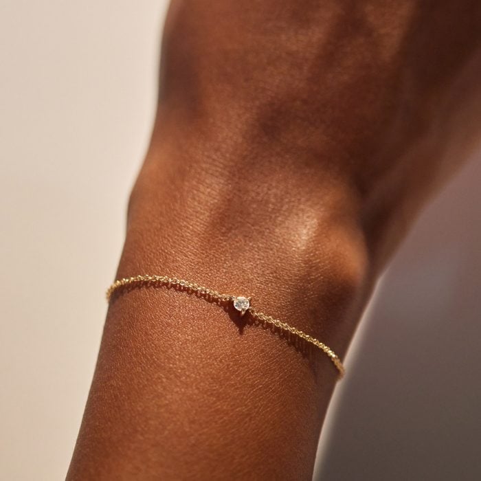 Gold permanent bracelet with a single diamond, welded to the wrist